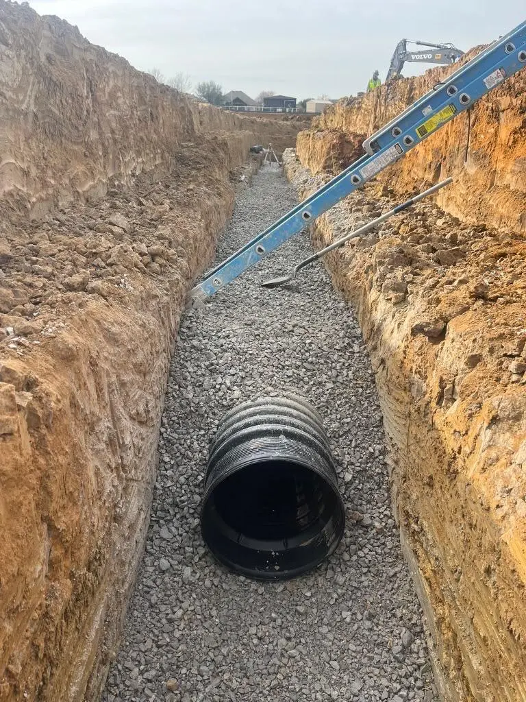 Storm pipe in a deep trench with crushed rock bedding delivered to the work