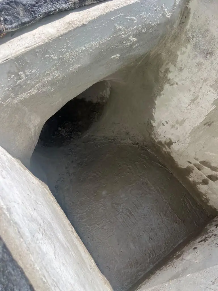 Hand-finished concrete flow channel inside a precast inlet structure