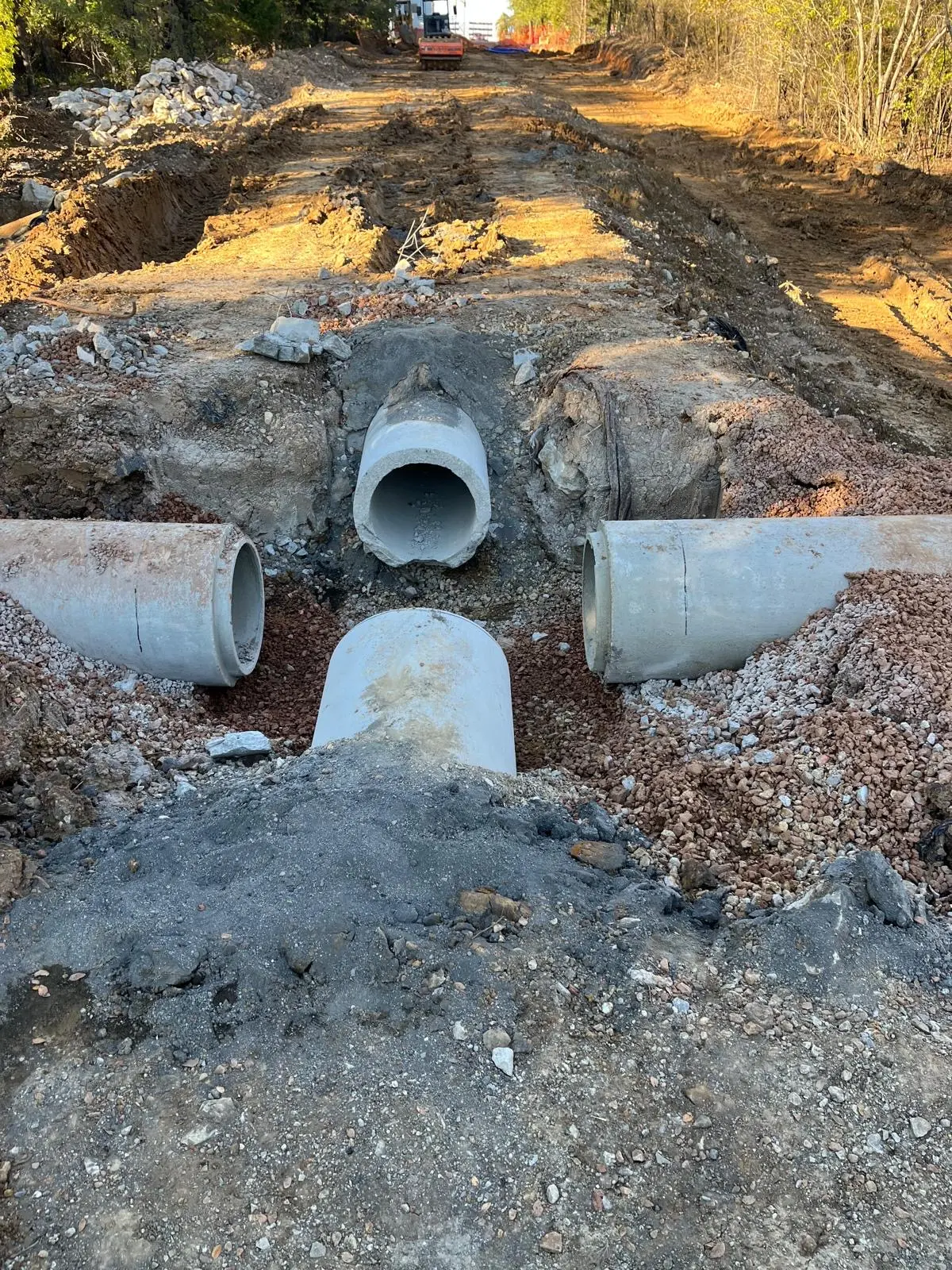 Reinforced concrete storm pipe junction connection on a wooded site